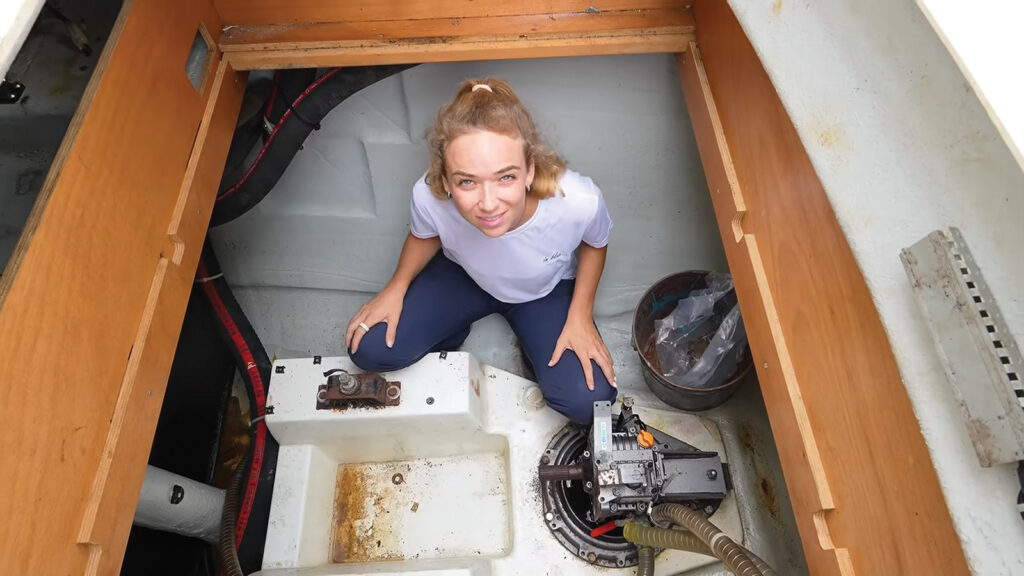 Sascha from Spear It Animal in the engine bay of their new boat